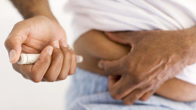 Man injecting himself with insulin