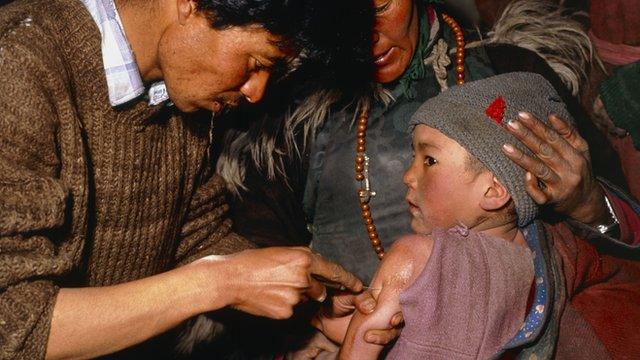 Child being given a measles vaccine in India
