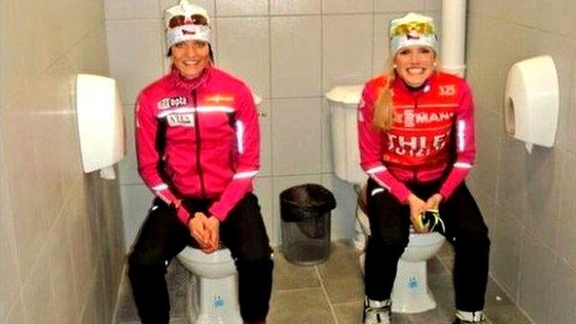 Athletes sitting on toilets side by side