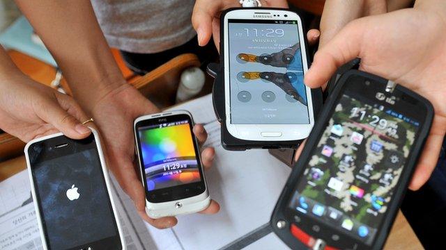 Children holding a selection of smartphones