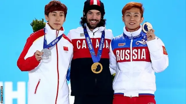 Silver medallist Tianyu Han of China, gold medallist Charles Hamelin of Canada and bronze medallist Victor An of Russia