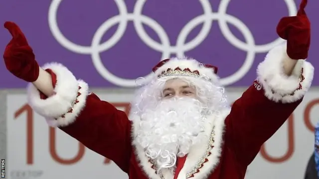 A fan awaits the start of the men's preliminary round ice hockey game between Canada and Norway