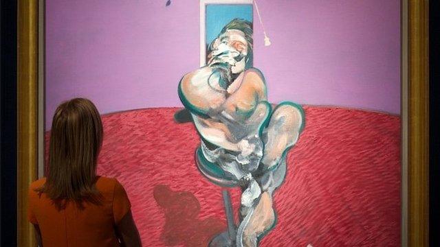 A woman looks the painting by Francis Bacon