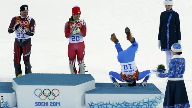 Christof Innerhofer does a somersault after winning bronze in the super combined