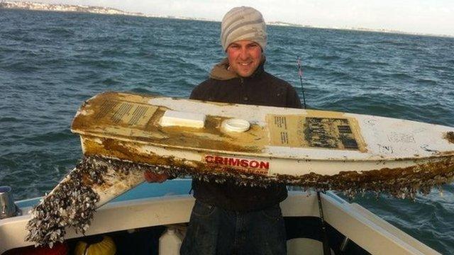 Paris Broe-Bougourd holding the 5ft unmanned boat