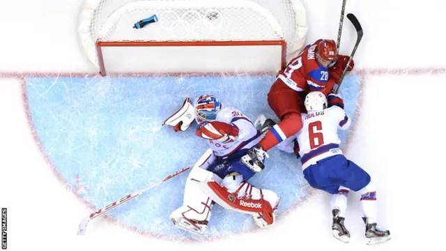 Russia's Alexander Syomin (top) vies with Norway's Jonas Holoes and Norway's goalkeeper Lars Haugen