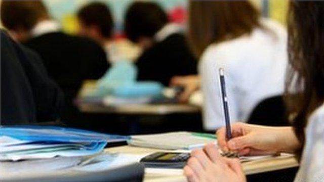 Close up pupil hand in classroom