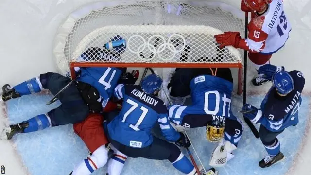 A goalmouth scramble between Russia and Finland