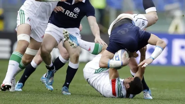 Scotland's Sean Lamont is tackled by Italy's Edoardo Gori