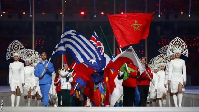 Flagbearers enter the stadium