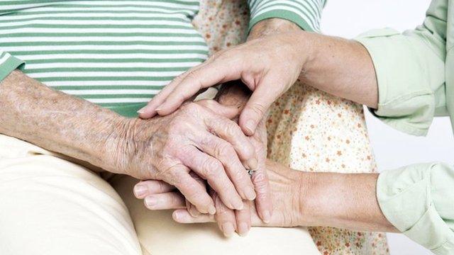 Woman being comforted by carer