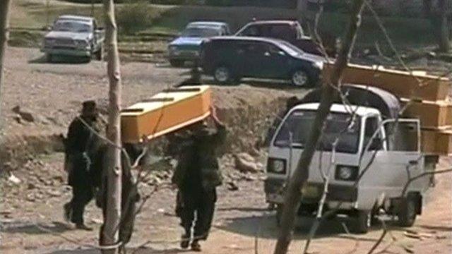 Coffins carried from scene of the bomb