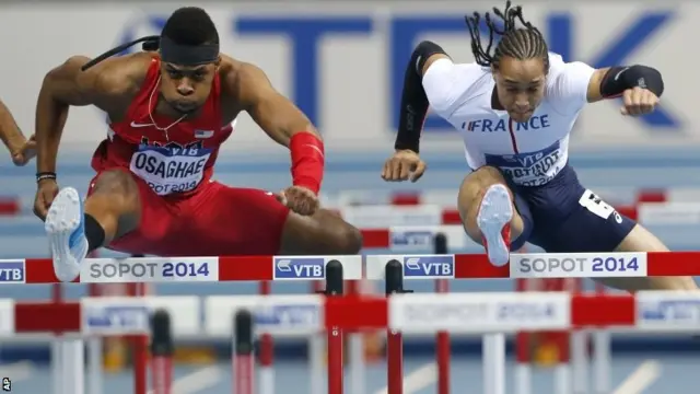 United States's Omo Osaghae, left, clears a hurdle next to France's Pascal Martinot-Lagarde to win the 60m hurdles