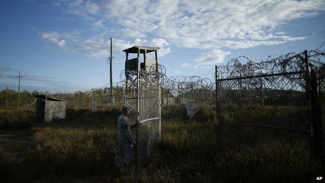 A soldier closes the gate at the now abandoned Camp X-Ray, which was used as the first detention facility at Guantanamo Bay Naval Base, Cuba, November 21, 2013