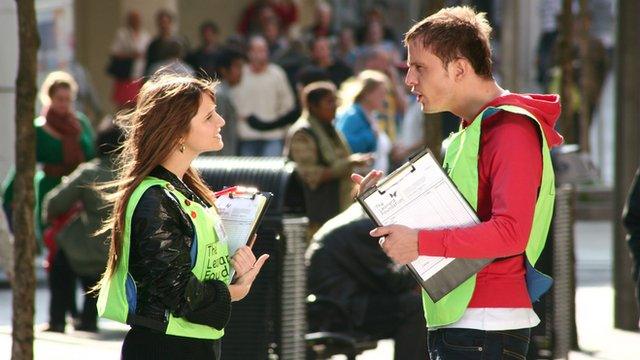 A scene from How Not To Live Your Life - showing street charity fundraisers