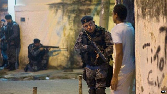 Heavily-armed police patrol a shanty town in Rio de Janeiro, on March 13, 2014