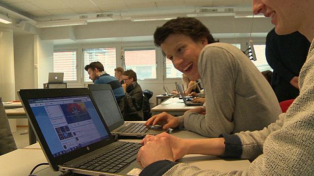 Students with computers in a classroom