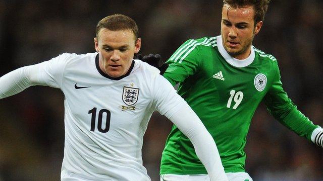 England's Wayne Rooney battles for possession with Mario Gotze of Germany at Wembley in November 2013