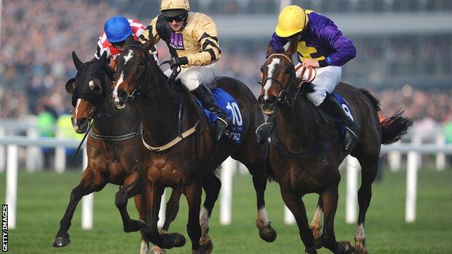 Davy Russell on Lord Windermere (right) surges ahead to win the Cheltenham Gold Cup from On His Own (centre) and The Giant Bolster (left)