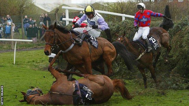 Warren Marston on Ardent Scout takes evasive action to avoid the fallen horse Bounce Back ridden by Andrew Thornton after they jumped Becher's Brook in the 2004 National