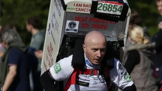 Athlete running with a fridge on his back