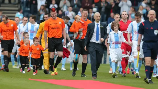 The Glenavon and Ballymena teams come out for the 2014 Irish Cup final