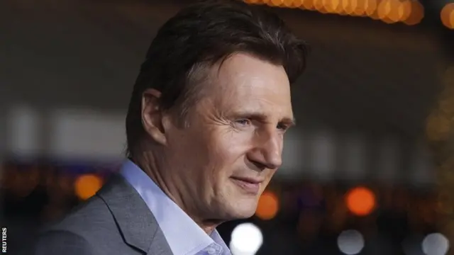 Liam Neeson poses at the premiere