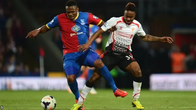 Crystal Palace's Kagisho Dikgacol, shields the ball from Liverpool's Raheem Sterling