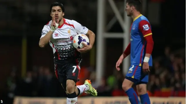 Uruguayan striker Luis Suarez celebrates scoring his side's third goal