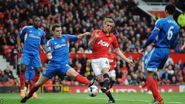 Hull City's Alex Bruce and Manchester United's James Wilson battle for the ball