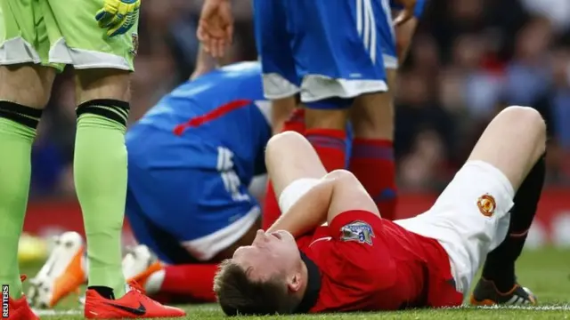 Phil Jones lies injured on the pitch