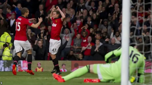 Manchester United's James Wilson, celebrates with teammate Nemanja Vidic