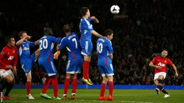 Manchester United's Ryan Giggs (R) takes a free kick