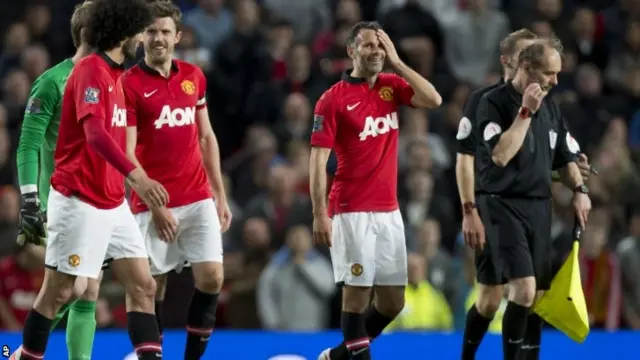 Manchester United's interim manager Ryan Giggs, smiles with his teammates