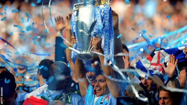 Manchester City with the Premier League trophy