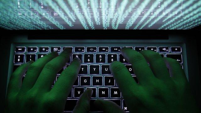 A man typing on a computer keyboard