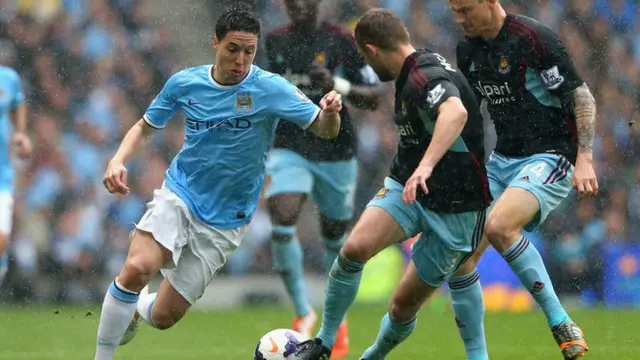 Manchester City's Samir Nasri tries to battle through the West Ham defence