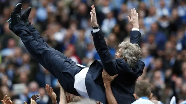 Man City manager Manuel Pellegrini is thrown into the air by his players