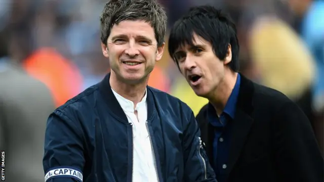 Oasis guitarist Noel Gallagher and Smiths guitarist Johnny Marr celebrate Manchester City's title success