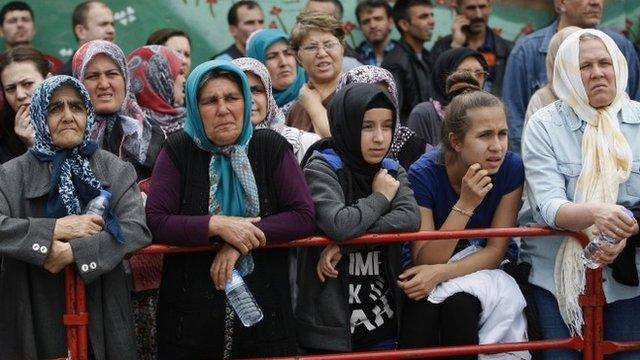 Relatives of miners wait in front of an hospital in Soma