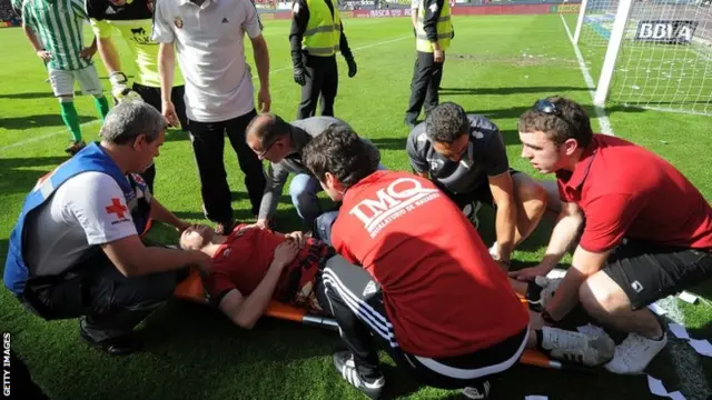 A fan is tended to after a barrier collapses in the La Liga match between Osasuna and Real Valladolid