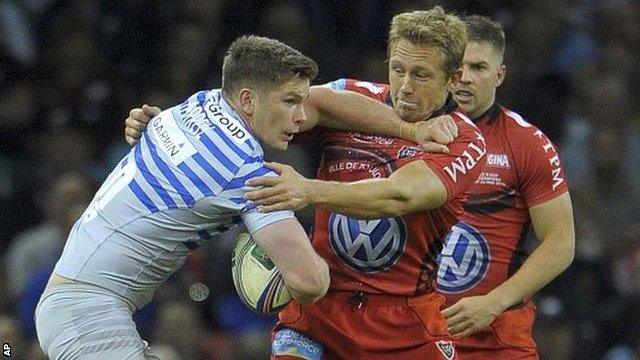 Owen Farrell of Saracens tries to make headway against Jonny Wilkinson