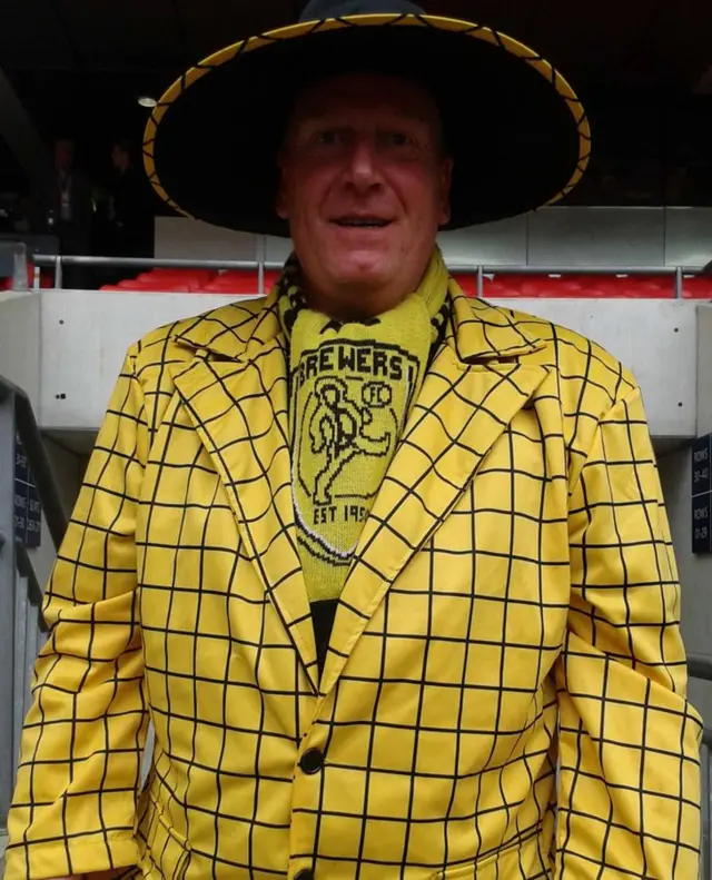 Burton fan in yellow suit