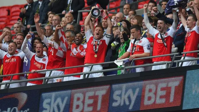 Fleetwood's players lift the League Two play-off trophy following their 1-0 win over Burton Albion