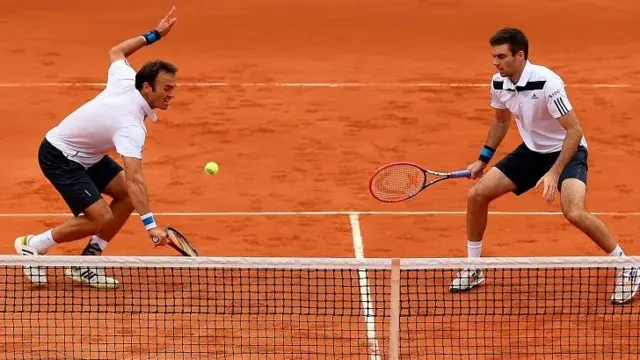 Ross Hutchins (left) and Colin Fleming of Great Britain in action during their men's doubles match against Santiago Gonzalez of Mexico and Scott Lipsky of the United States