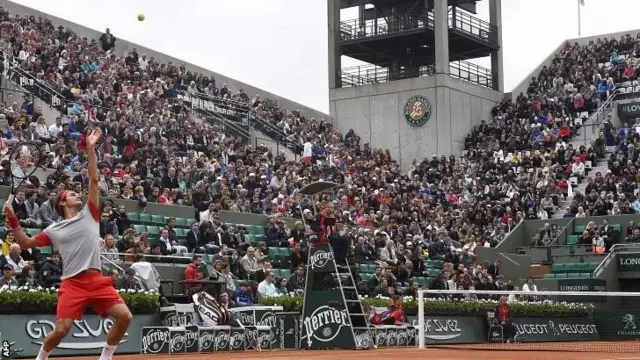 Roger Federer serves