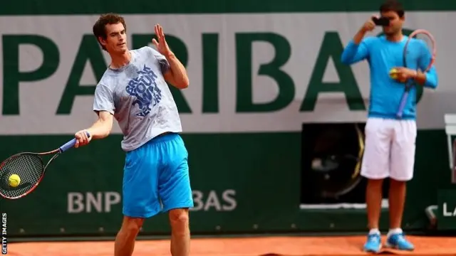 Dani Vallverdu records Andy Murray of Great Britain as he trains during a practice session