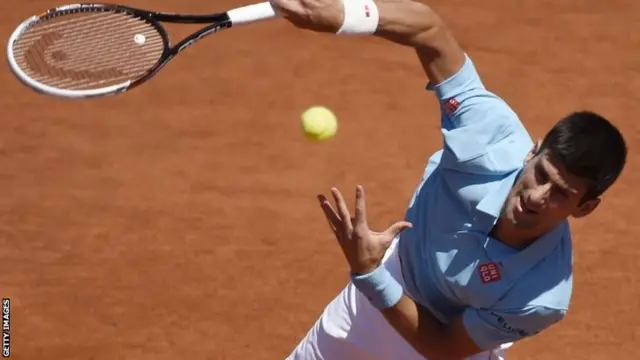 Novak Djokovic serves at French Open