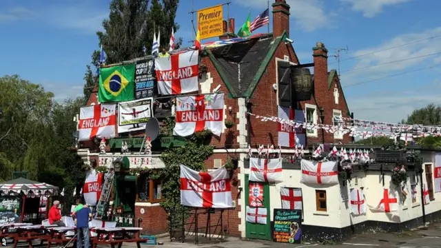 Decorations and flags outside The Robin Hood public house, in Jarrow, England