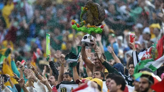 Mexico fans in Brazil celebrate their lead against Cameroon